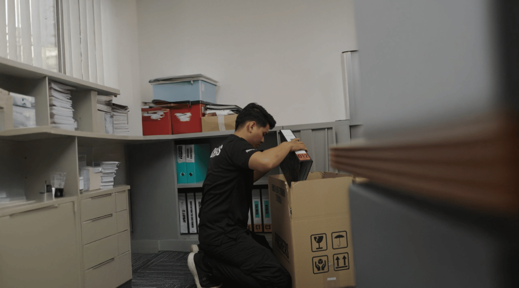 Packaging important files in a box during Office Moving Services at Packers Xpress
